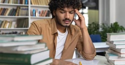 male studying with books