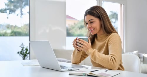 female studying with cup in hand