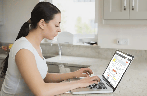 woman on laptop studying for ged test using ged academy